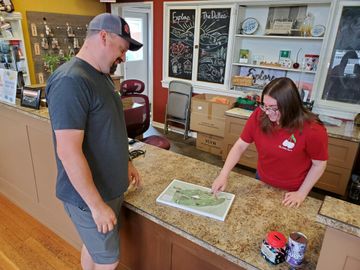 A Hood-Gorge staff member uses the Infinity Loop Map as an helpful aid when assisting a visitor.